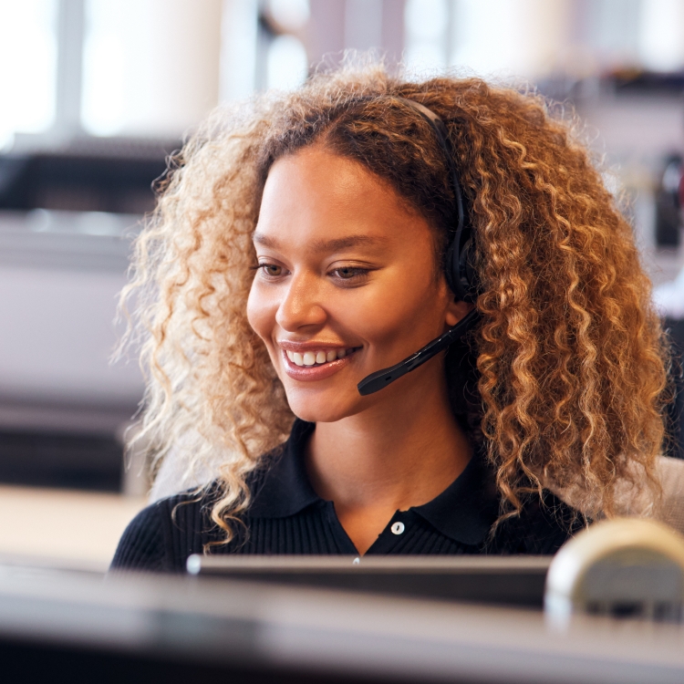 Smile female on the phone with a client.