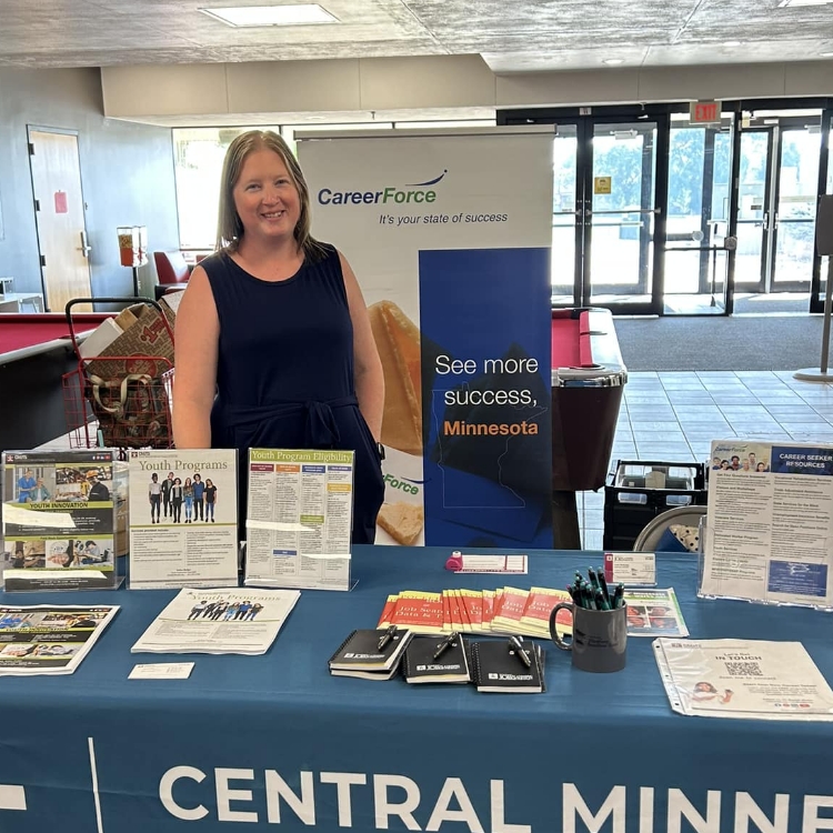 Lady at the CMJTS Career Fair booth. 